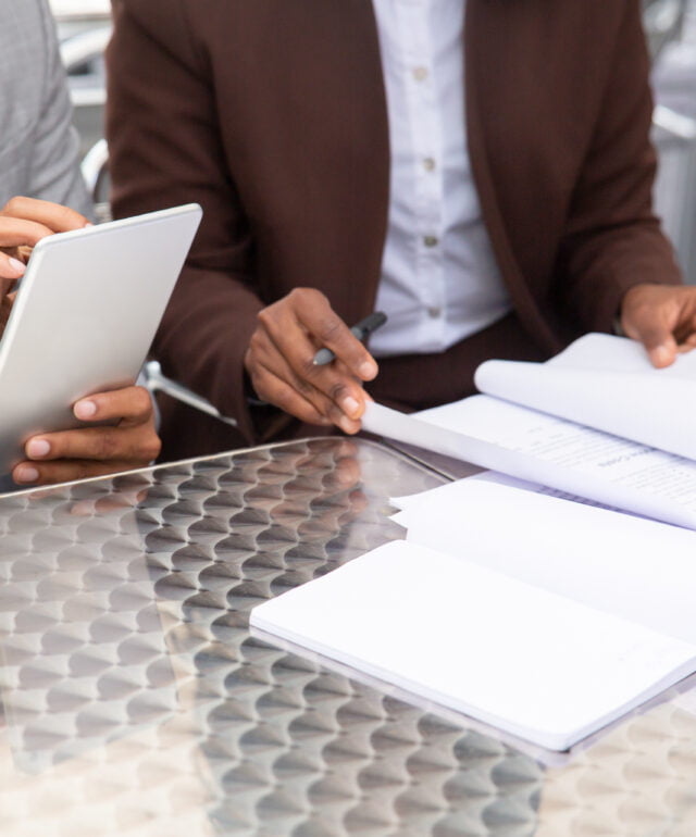 Cropped shot of two businesspeople working with documents Cropped shot of two businesspeople working with documents